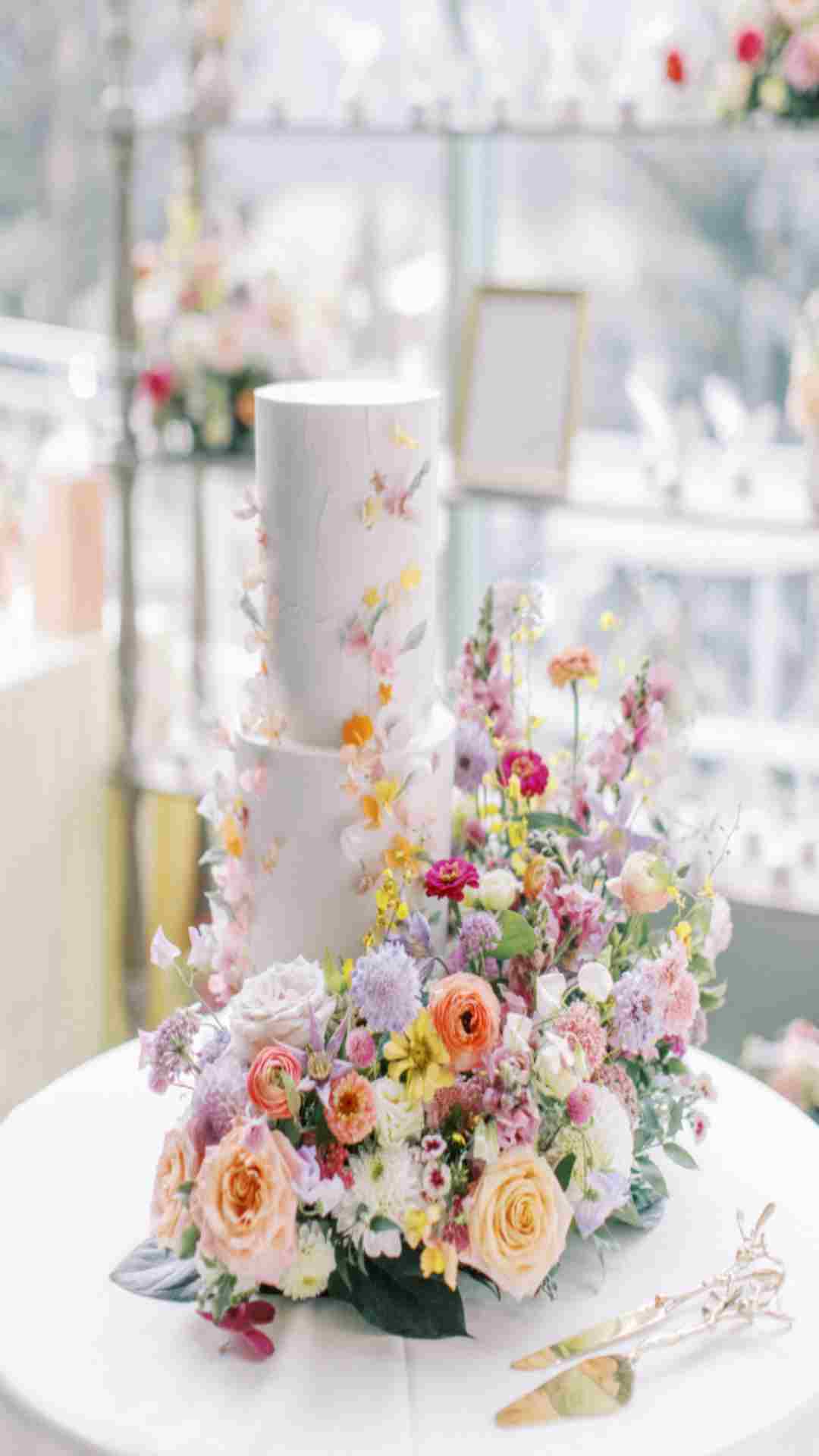 Elegant wedding cake decorated with fresh real flowers